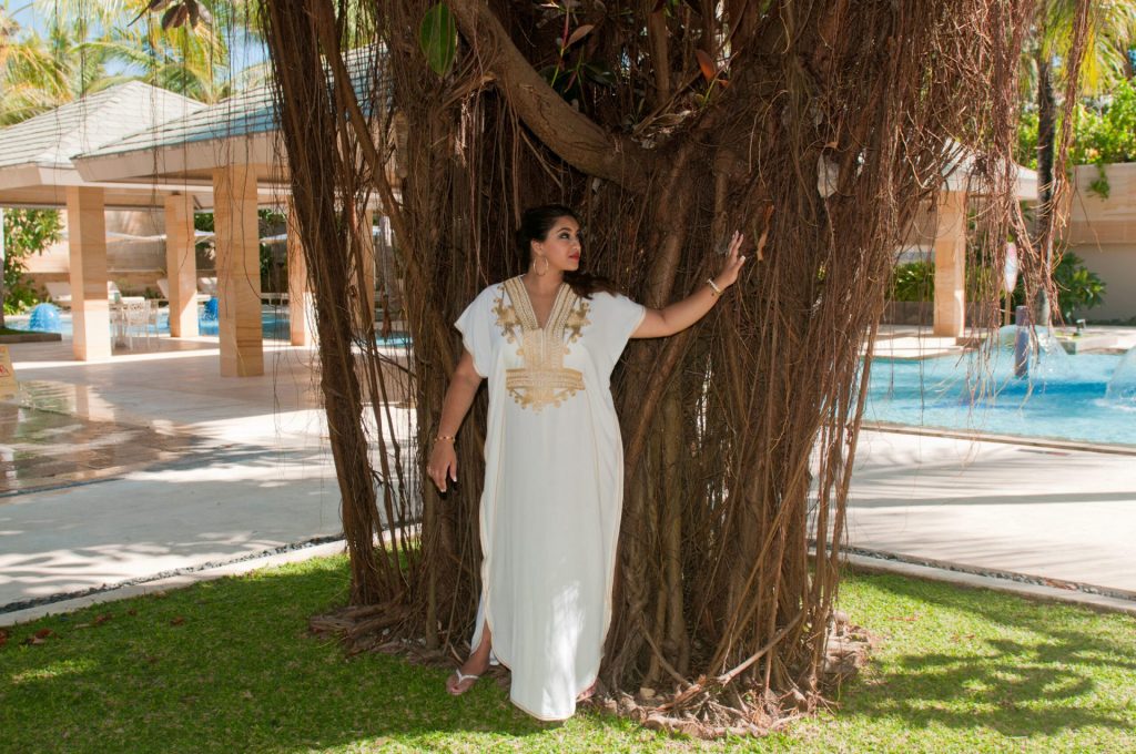 Lady standing in front of tree grounding her energy