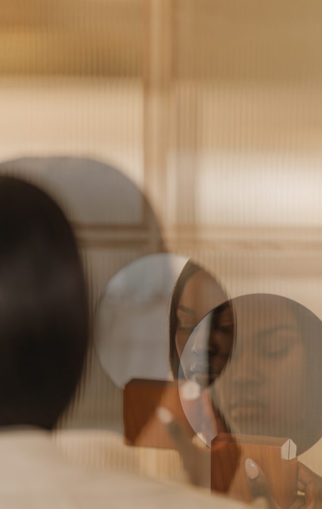 lady with dark feminine energy looking in mirror