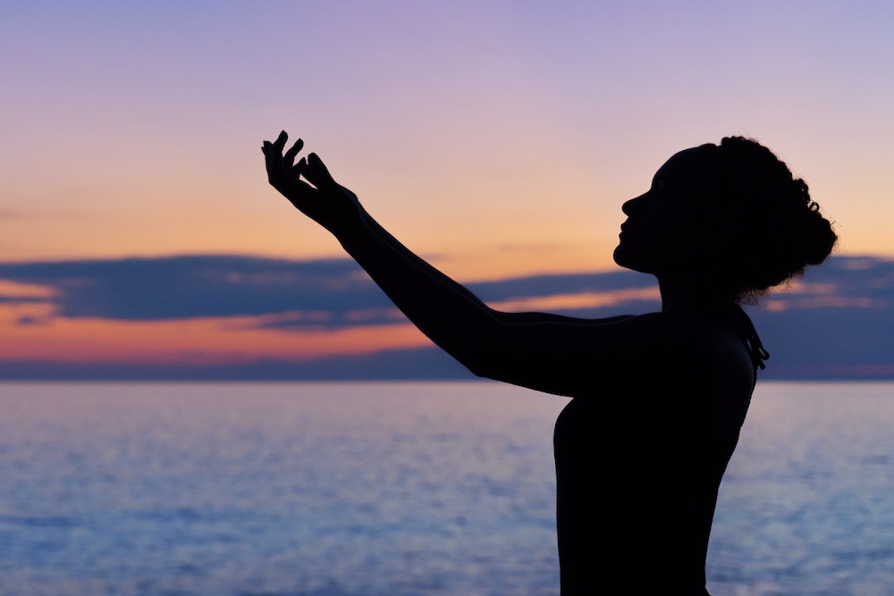 lady standing in front of sky 